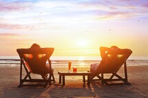 Couple enjoying the sunset at a beach in Goa Couple enjoying the sunset at a beach in Goa
