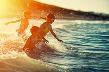 Children playing in the water at a beach in Goa Children playing in the water at a beach in Goa