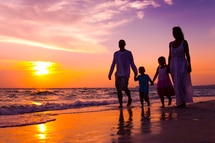 A family walking on the beach in Goa A family walking on the beach in Goa