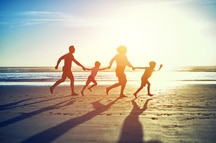 A family having fun on the beach in Goa A family having fun on the beach in Goa