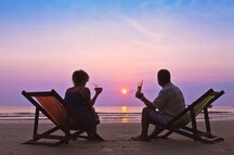 A couple enjoying a breathtaking sunset in Goa A couple enjoying a breathtaking sunset in Goa