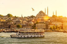 Tourist boat floats on the Golden Horn in Istanbul at sunset, Turkey Tourist boat floats on the Golden Horn in Istanbul at sunset, Turkey