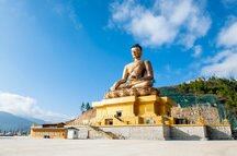 A giant Buddha statue under blue sky in Thimphu Bhutan A giant Buddha statue under blue sky in Thimphu Bhutan